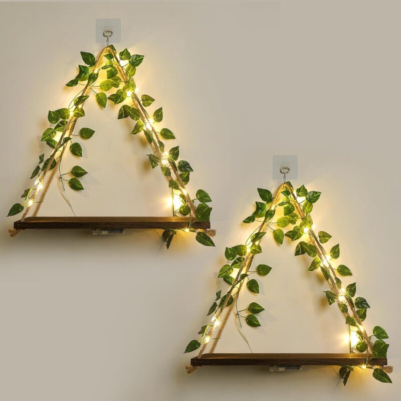 A set of two JOPSTDI White Flower floating triangle shelves with artificial ivy and LED lights, mounted on a wall.