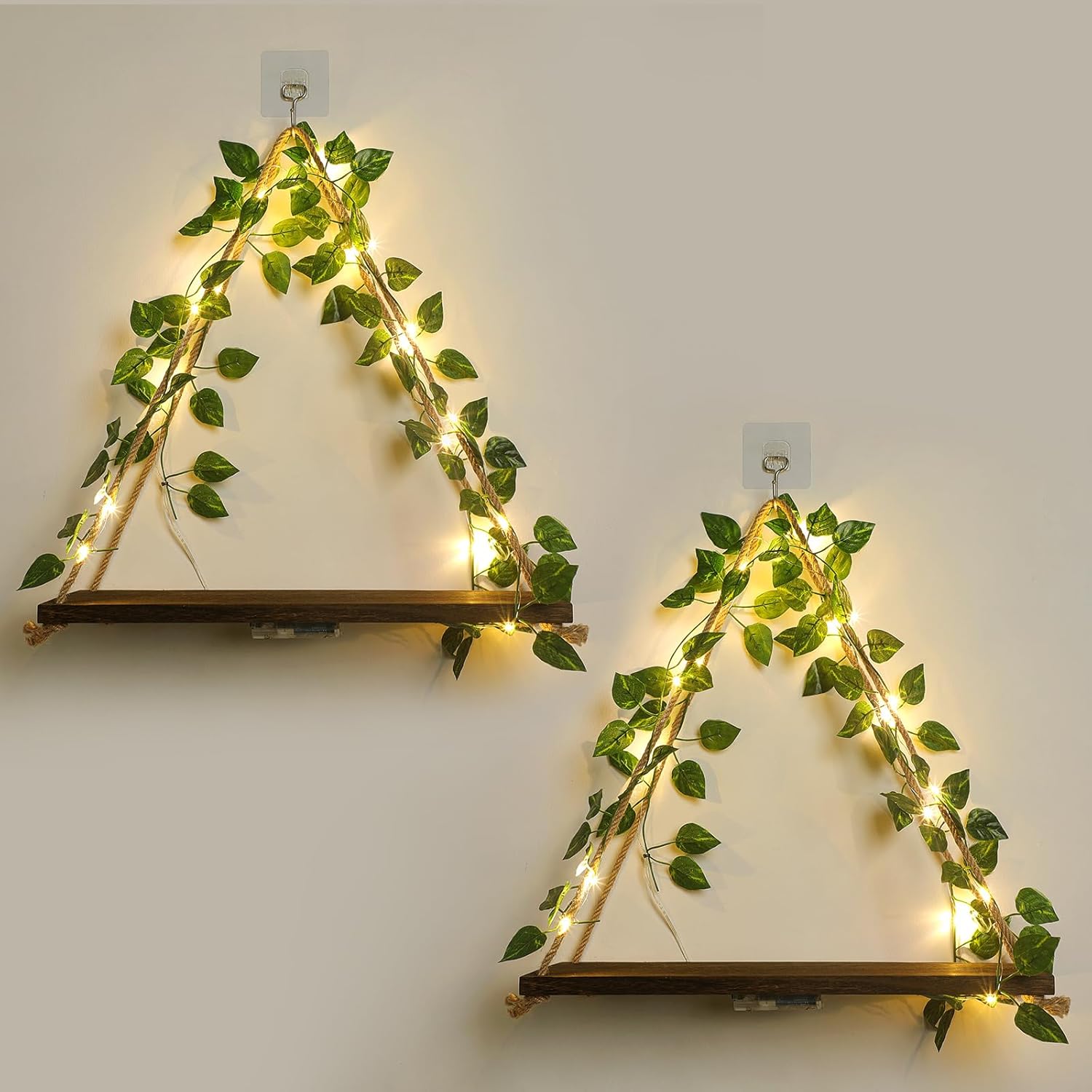 jopstdi-2-pack-white-flower-floating-triangle-shelves-with-ivy-led-lights-01 A set of two JOPSTDI White Flower floating triangle shelves with artificial ivy and LED lights, mounted on a wall.